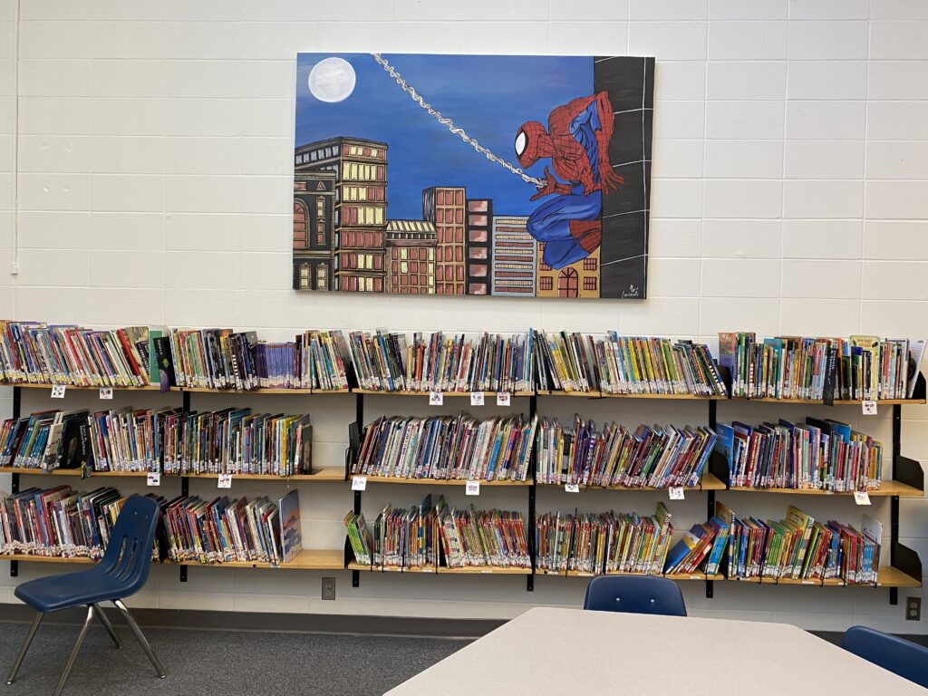 Hand painted canvas by Edmonton artist Carly Marie for St.Albert Kenoshayo Elementary School library. Large canvas of Spider-man with cityscape and the moonlit sky